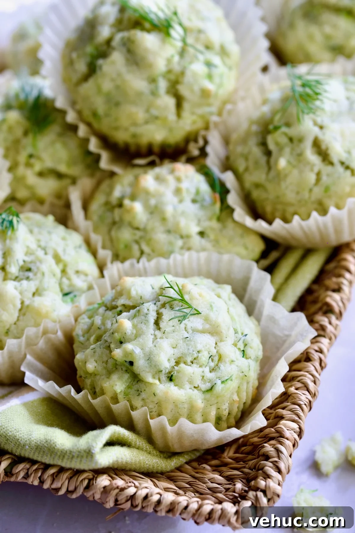 Zucchini Ricotta Dill Muffins: Savory Summer Snack 2 Pile of Dill Zucchini and Ricotta Muffins on square rattan basket.
