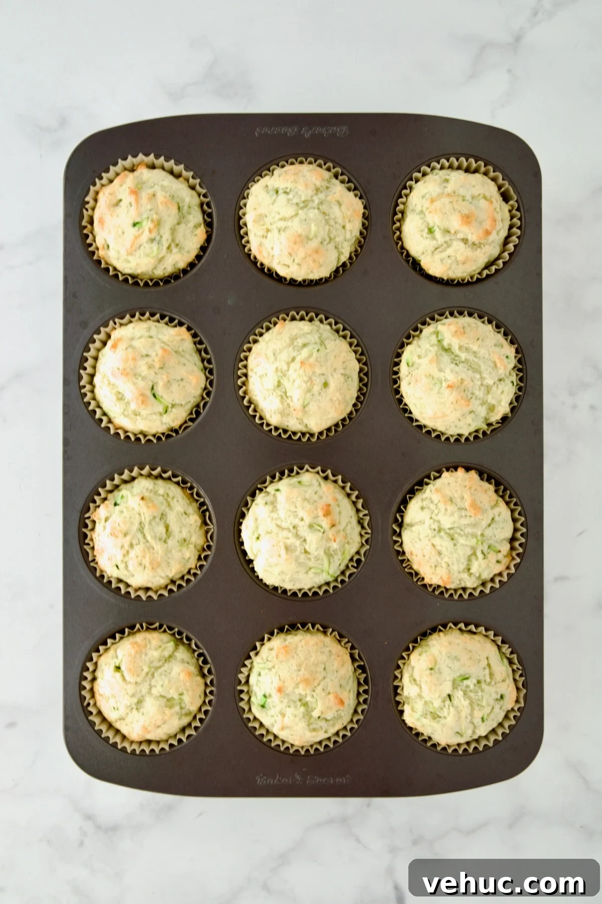Zucchini Ricotta Dill Muffins: Savory Summer Snack 11 Baked Dill Zucchini and Ricotta Muffins in 12-cup muffin pan.