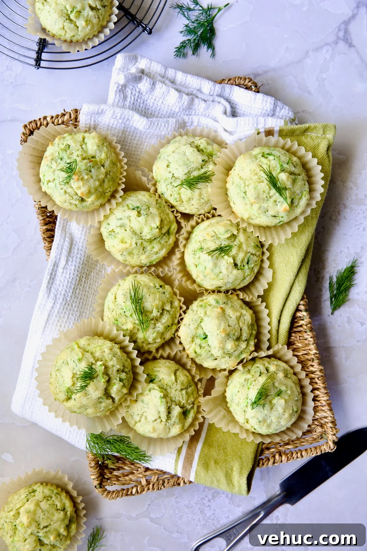 Zucchini Ricotta Dill Muffins: Savory Summer Snack 12 Pile of Dill Zucchini and Ricotta Muffins on square rattan basket.