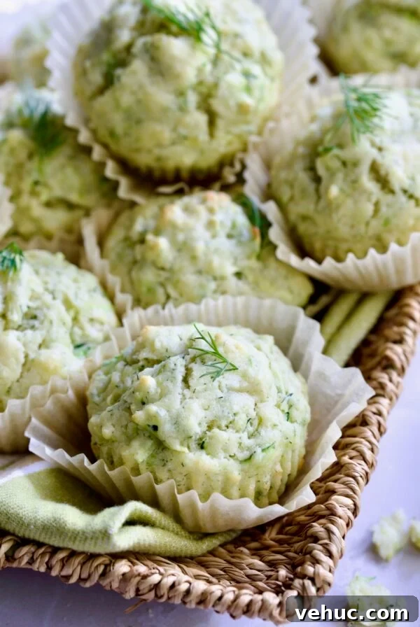 Zucchini Ricotta Dill Muffins: Savory Summer Snack 15 Pile of Dill Zucchini and Ricotta Muffins on square rattan basket.