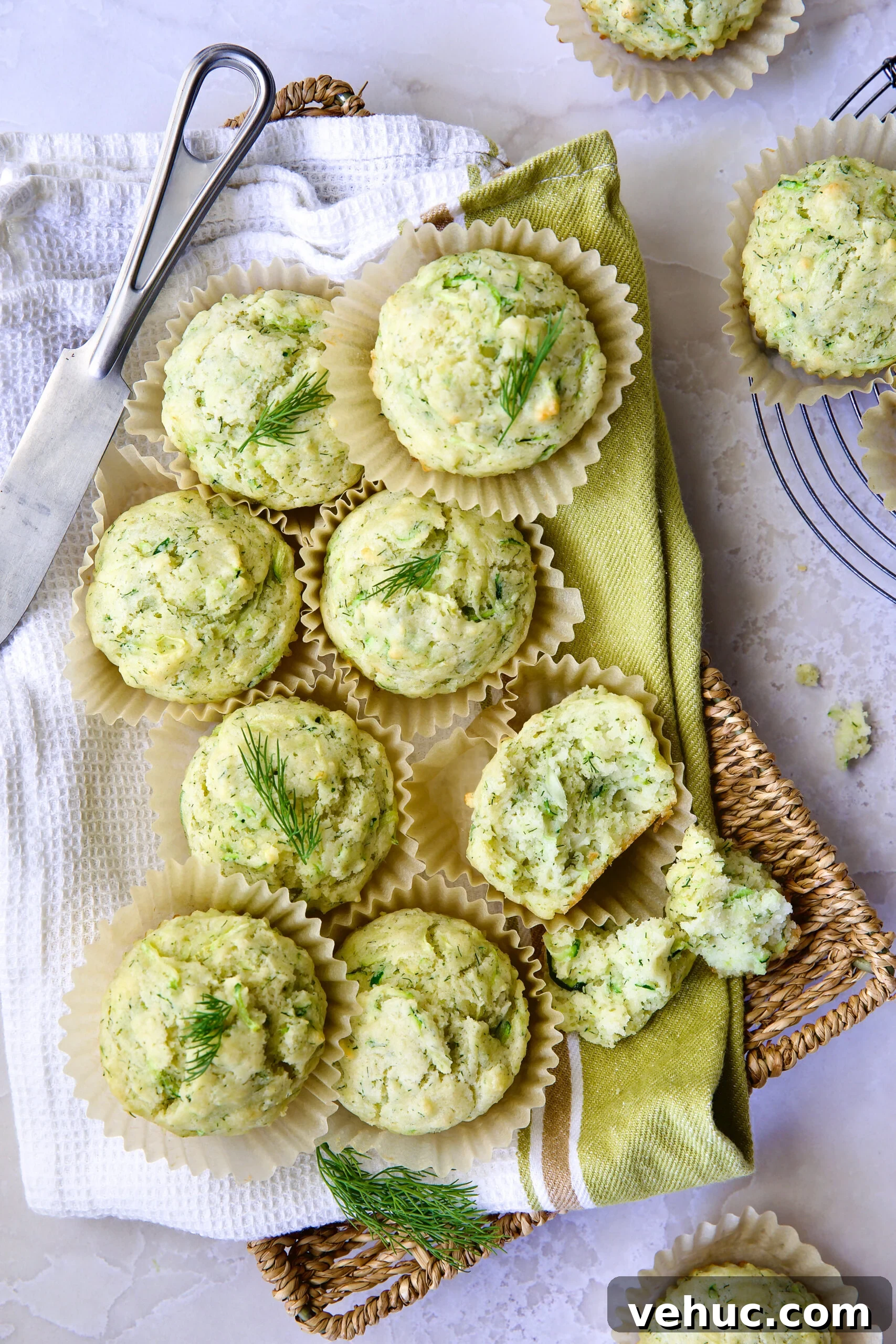 Zucchini Ricotta Dill Muffins: Savory Summer Snack 5 Pile of Dill Zucchini and Ricotta Muffins on square rattan basket.