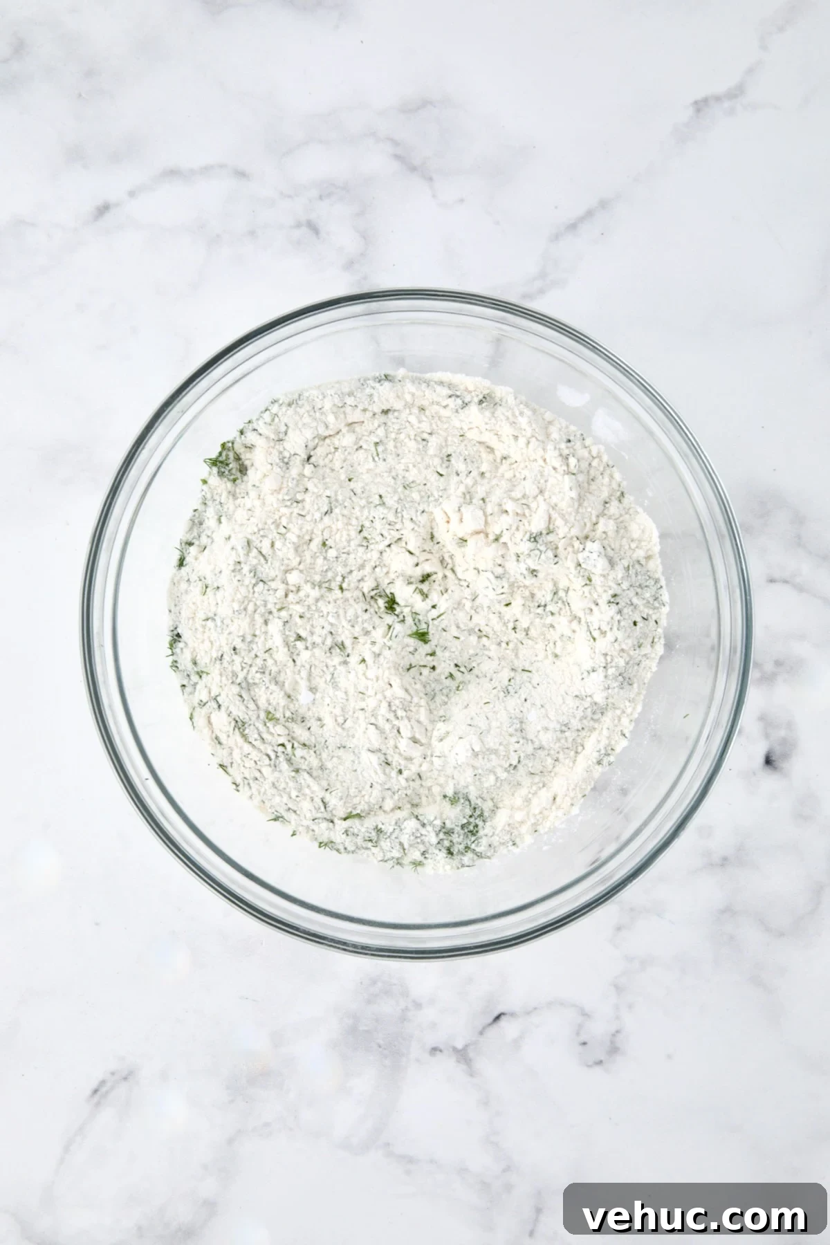 Zucchini Ricotta Dill Muffins: Savory Summer Snack 7 Dry ingredients for muffins in a glass bowl.