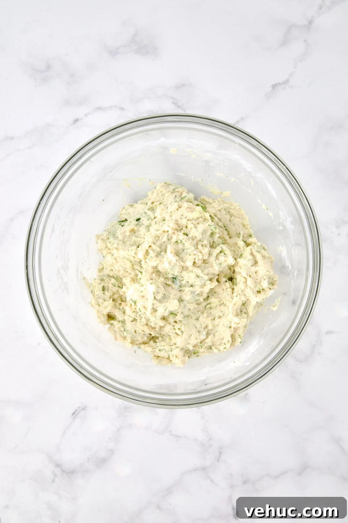 Zucchini Ricotta Dill Muffins: Savory Summer Snack 9 Wet and dry ingredients for muffins combined in glass bowl.
