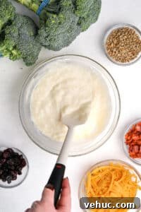 Crispy Broccoli Salad with Creamy Parmesan Dressing 17 Stirring together a creamy dressing with a silicone spatula.