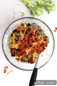 Crispy Broccoli Salad with Creamy Parmesan Dressing 19 A bowl of broccoli salad with bacon and cheese mixed in.
