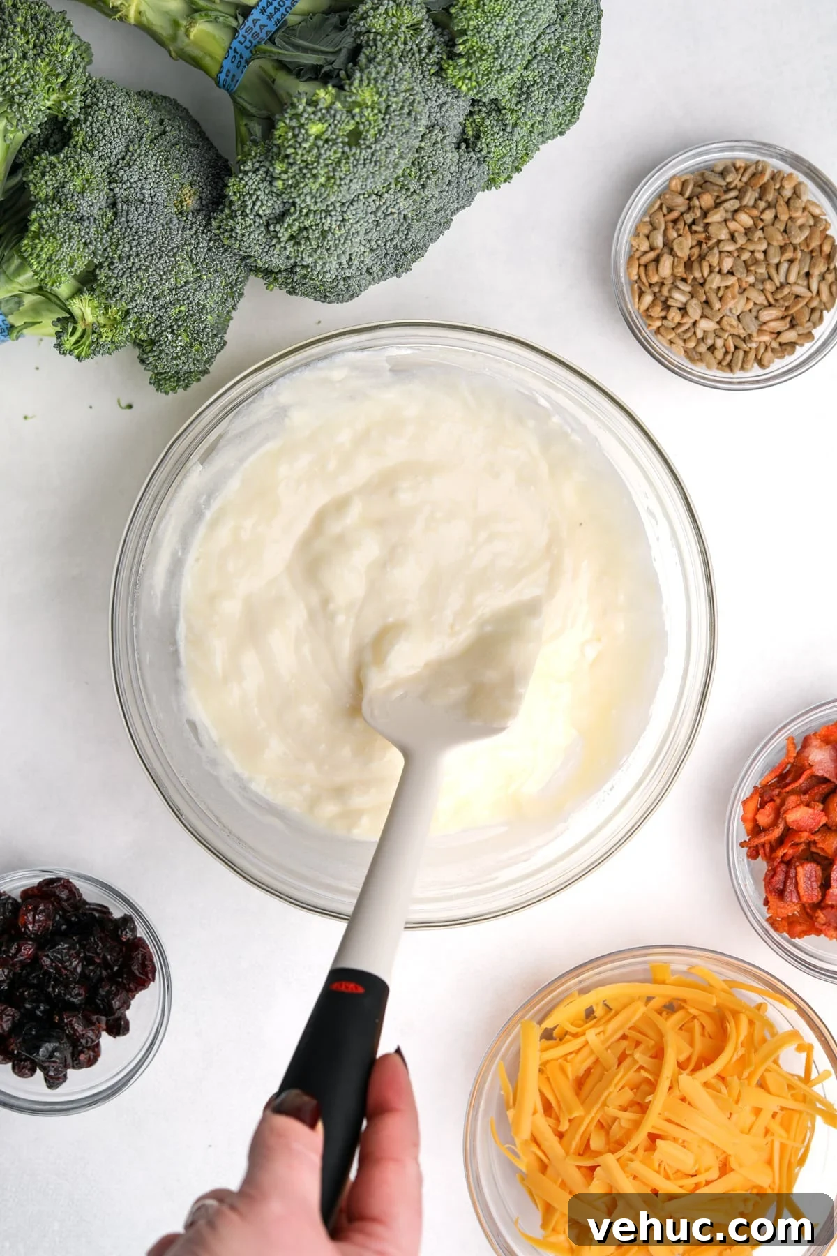 Crispy Broccoli Salad with Creamy Parmesan Dressing 5 Stirring together a creamy dressing with a silicone spatula.