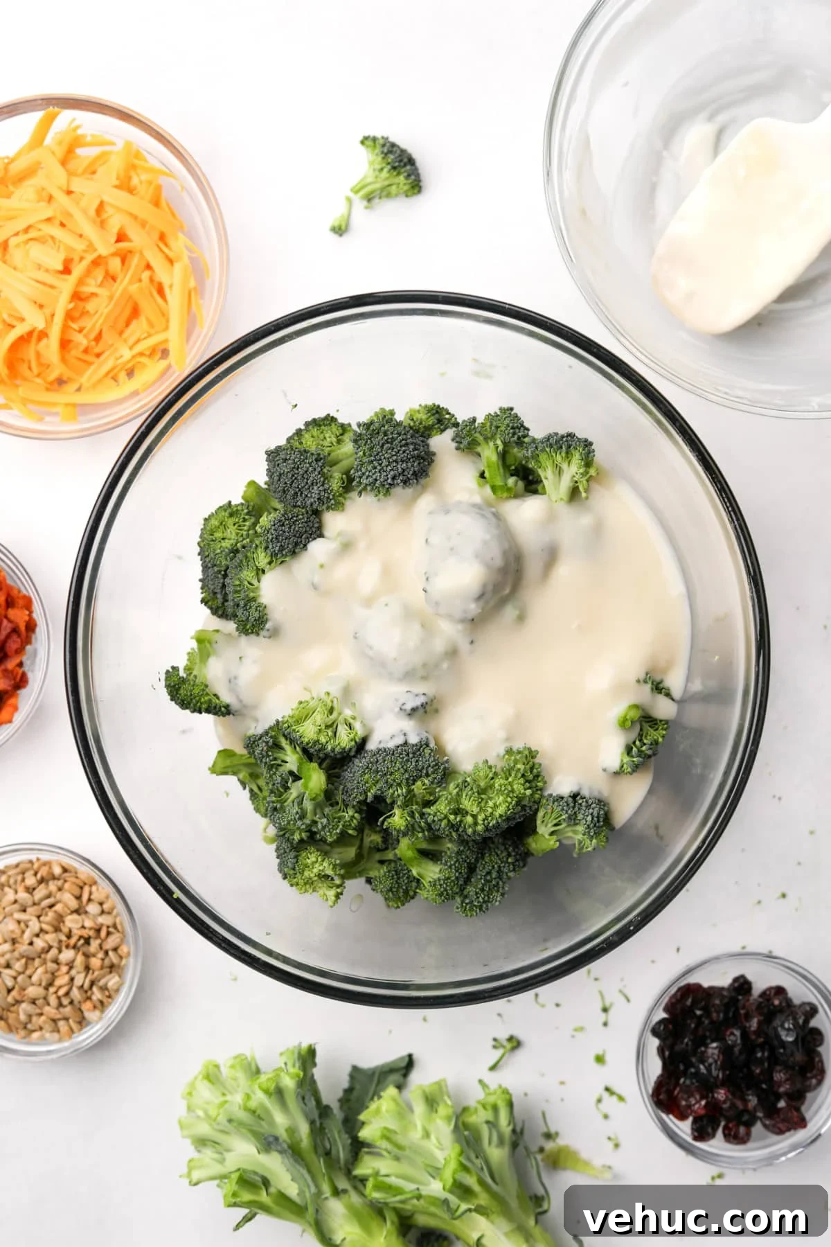 Crispy Broccoli Salad with Creamy Parmesan Dressing 7 A bowl of broccoli with a creamy dressing poured on top.
