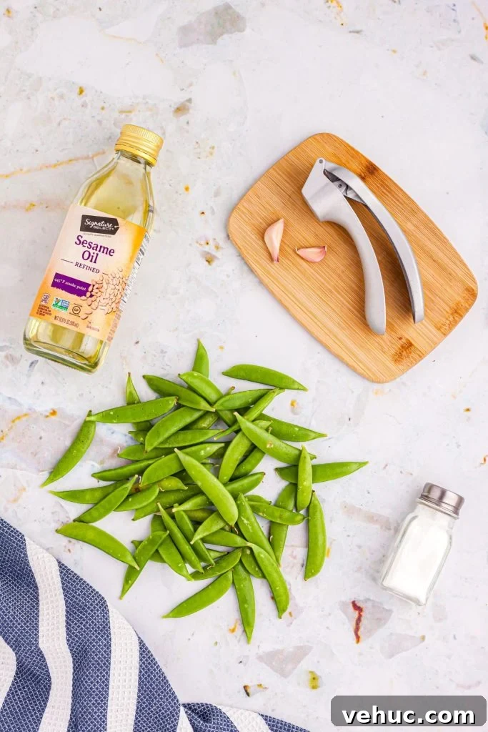Crispy Air-Fried Sugar Snap Peas in Minutes 3 Sesame oil, salt, garlic and snap peas on a marble table