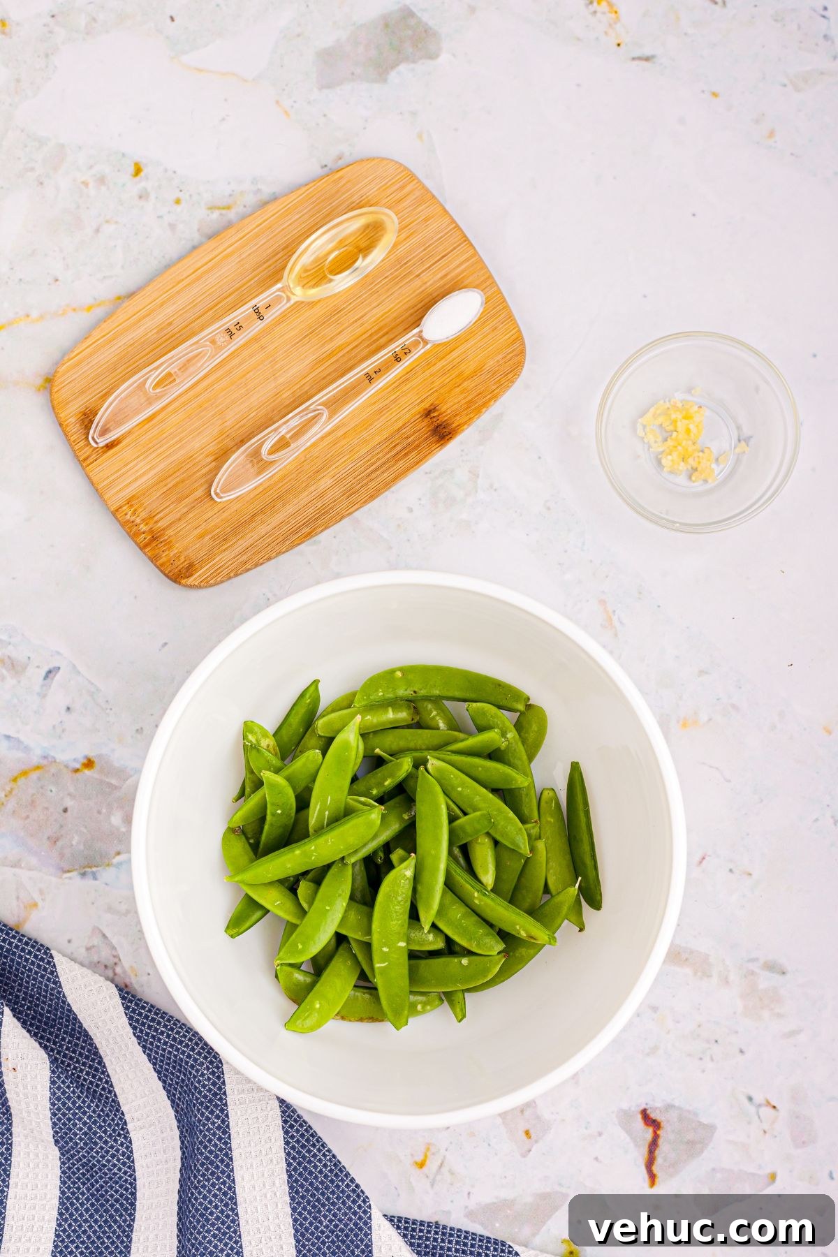 Crispy Air-Fried Sugar Snap Peas in Minutes 4 Snap peas in a white bowl after being rinsed and having ends removed