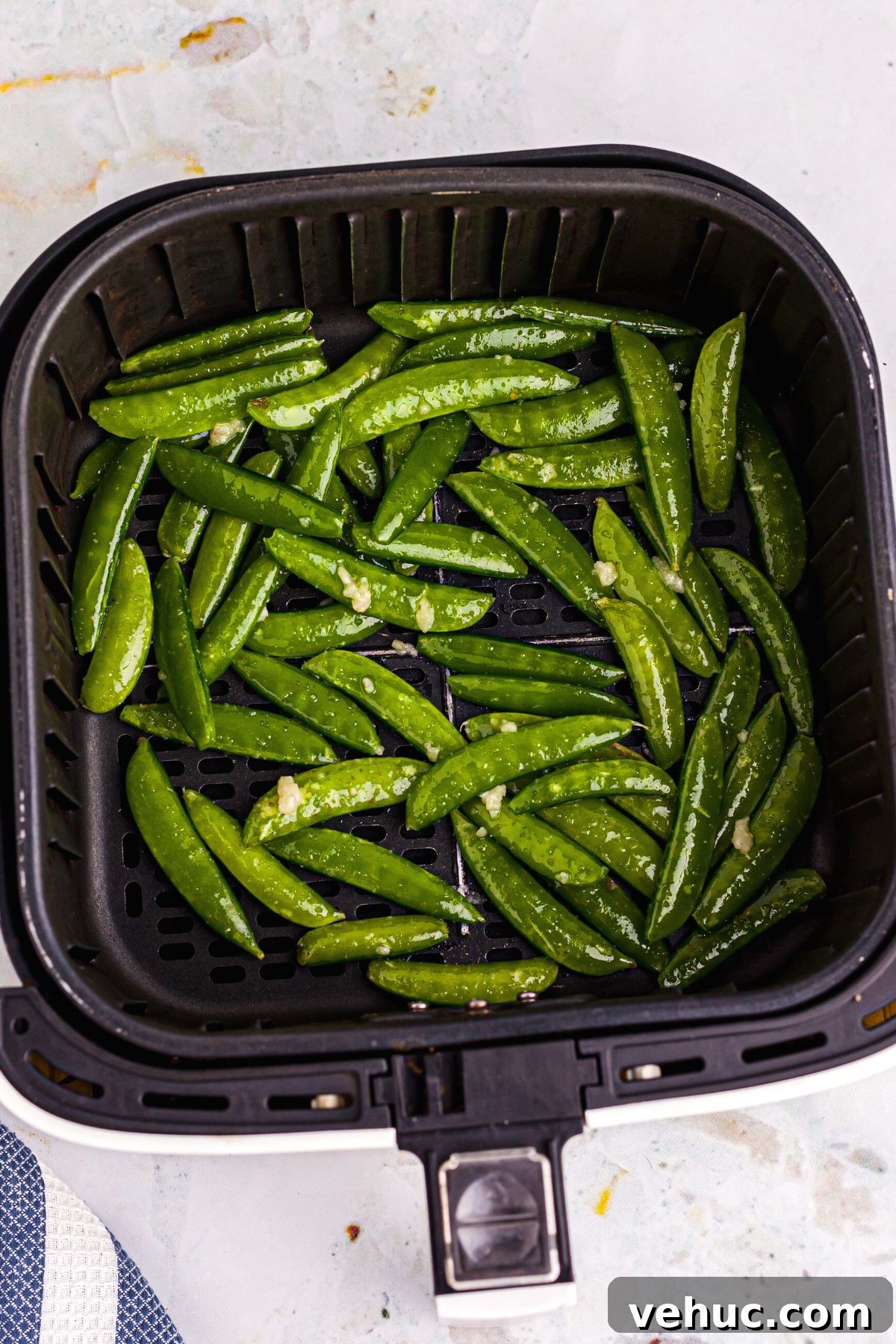 Crispy Air-Fried Sugar Snap Peas in Minutes 6 Green Snap peas tossed with olive oil in the air fryer basket before being cooked