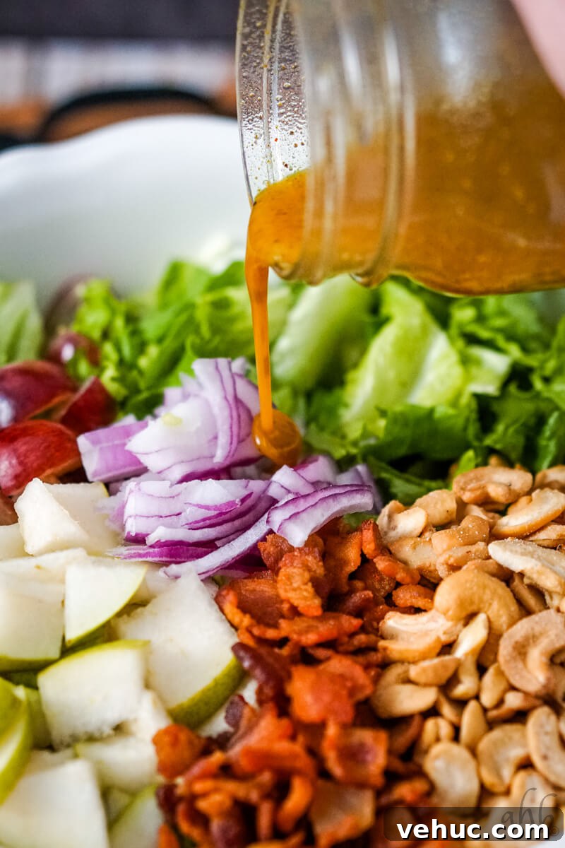 Crispy Cashew Salad with Lime Dressing: Refreshing Crunch Bowl 7 The vinaigrette is poured over the salad.