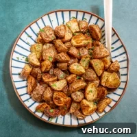 Roasted potato chunks sprinkled with chopped fresh herbs.