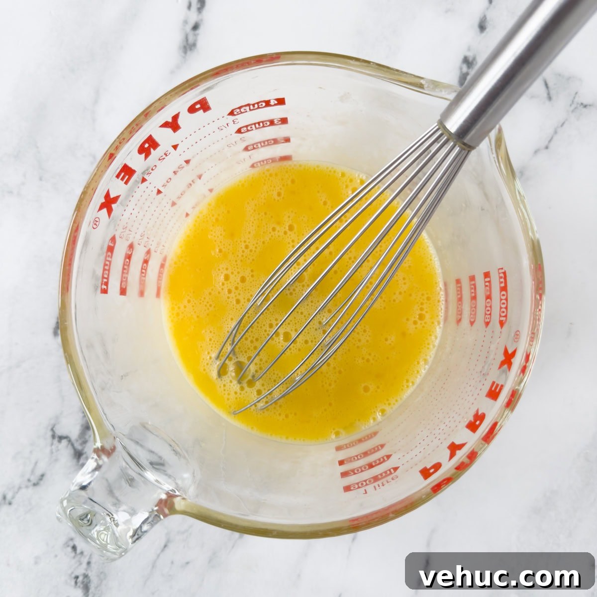 Gluten-Free Dutch Baby Pancake Recipe (German Pancake) 4 Whisking eggs in a pyrex measuring cup until smooth.