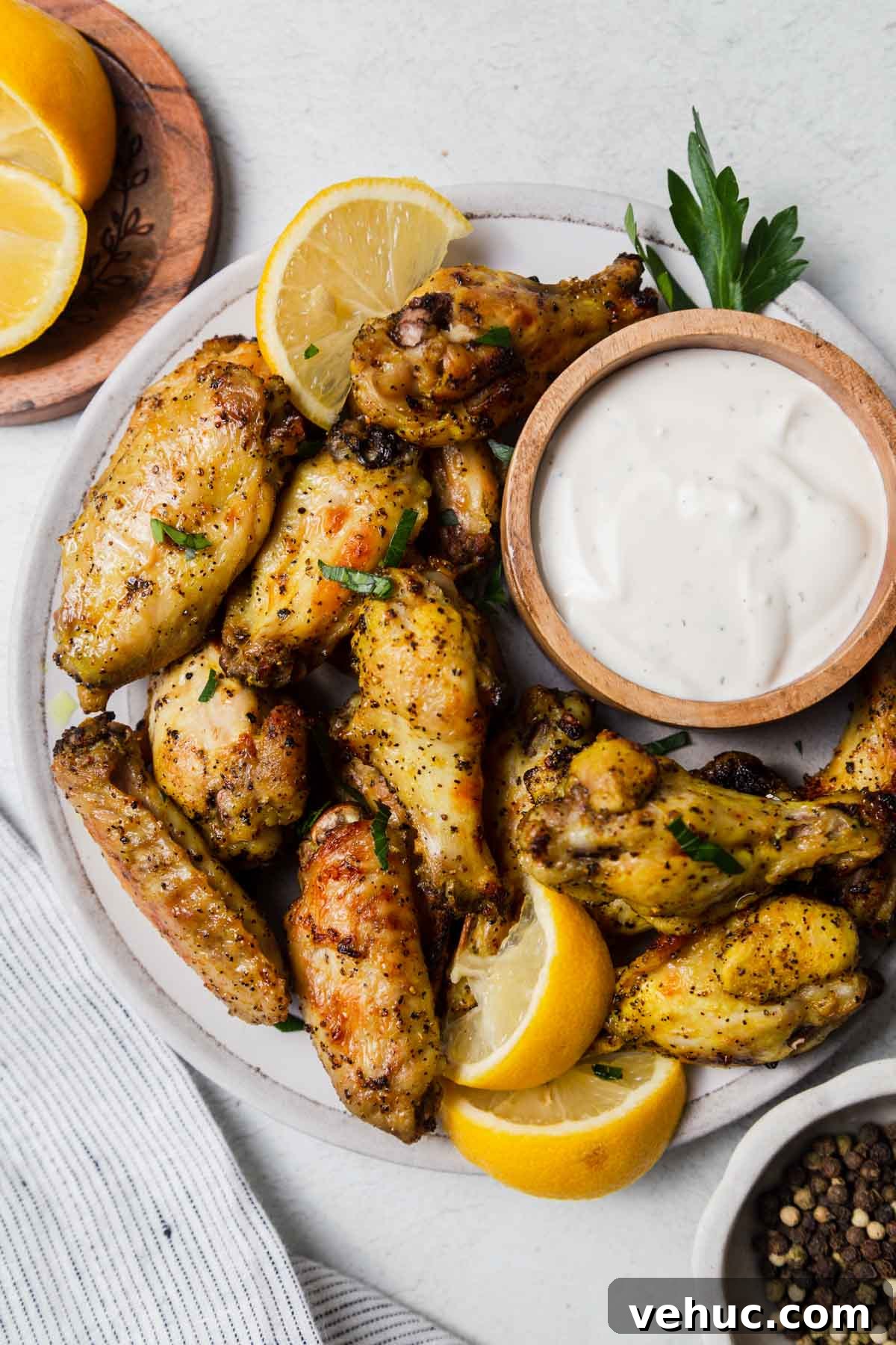 Crispy Lemon Pepper Air Fryer Chicken Wings 2 air fried lemon pepper chicken wings with ranch dressing.