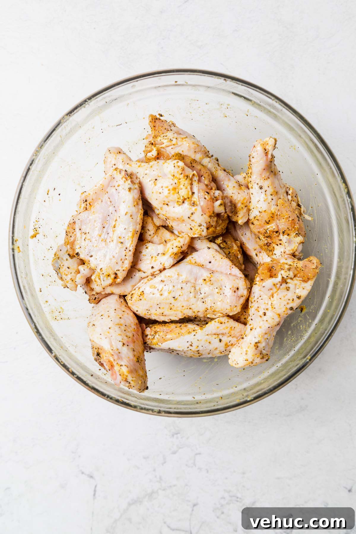 Crispy Lemon Pepper Air Fryer Chicken Wings 5 seasoned chicken wings for lemon pepper wings in the air fryer.