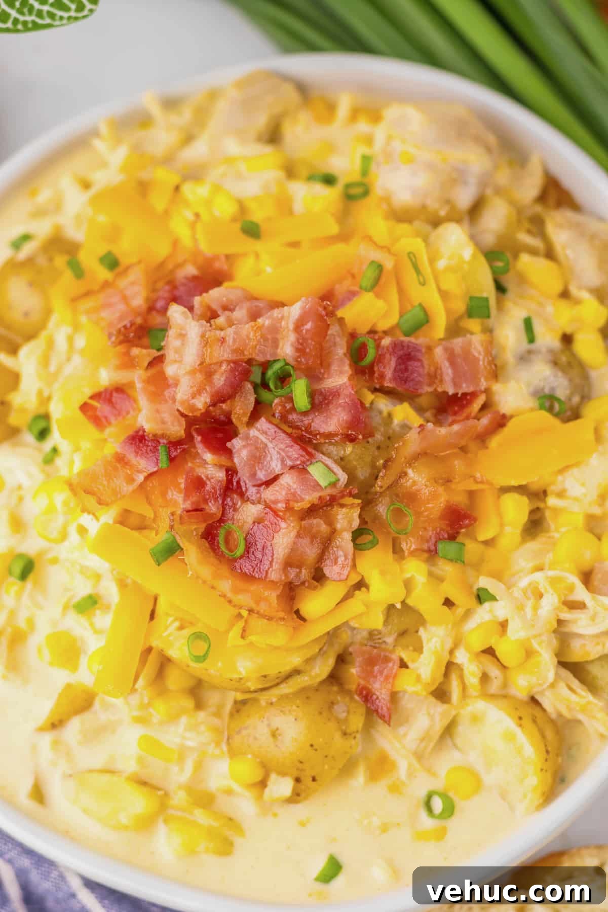 Slow Cooker Creamy Chicken and Corn Chowder Recipe 2 White bowl filled with chicken corn chowder.