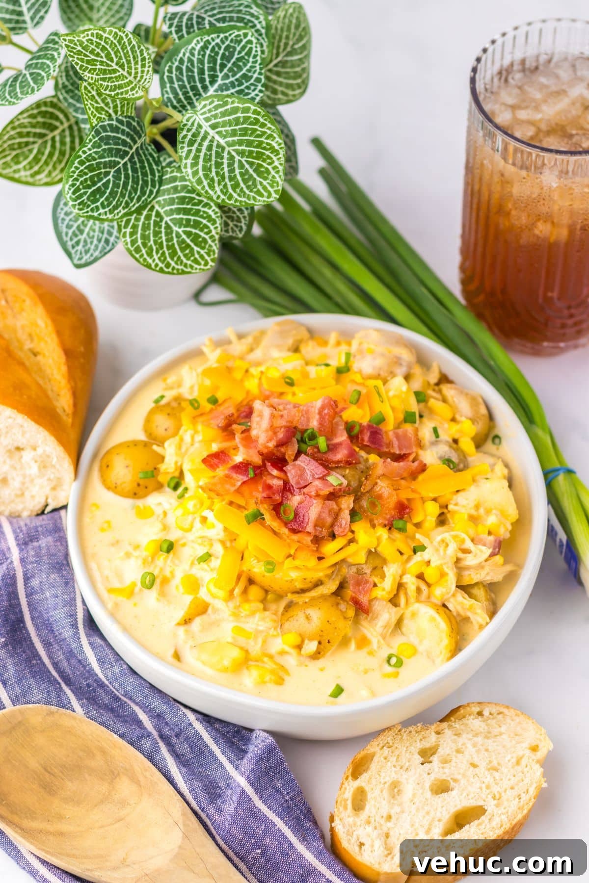 Slow Cooker Creamy Chicken and Corn Chowder Recipe 3 White bowl filled with chicken corn chowder.
