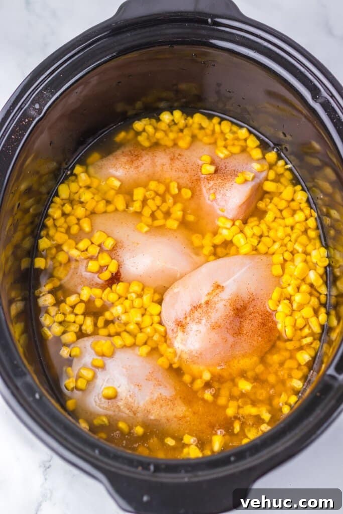 Slow Cooker Creamy Chicken and Corn Chowder Recipe 6 Broth being added to a crockpot.
