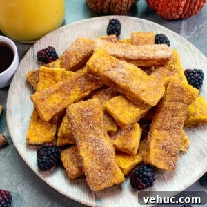 Pumpkin Churro French Toast Sticks Recipe for Fall Brunch 6 Pumpkin churro French toast sticks stacked up on a plate.