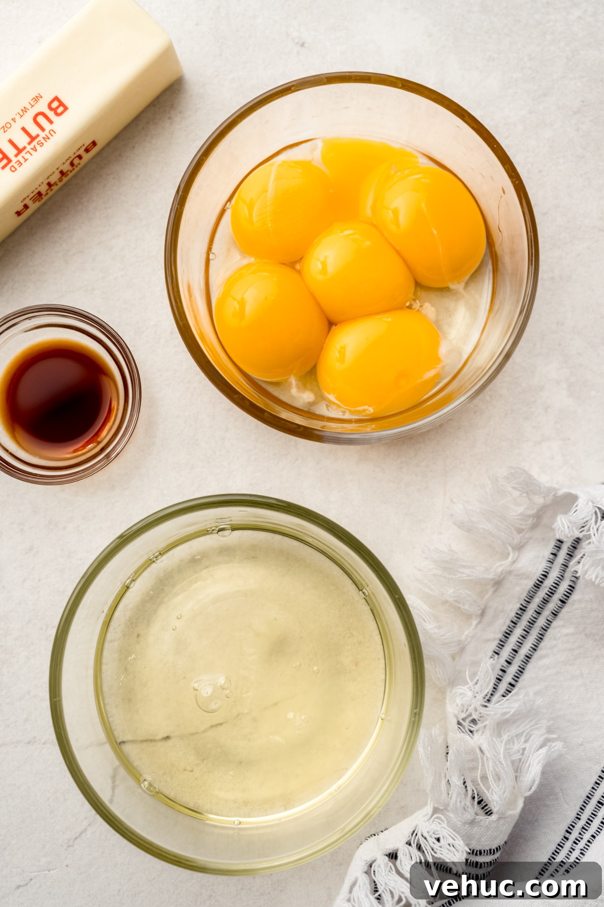 Decadent Butter Pecan Layer Cake Recipe 14 Aerial photo of a bowl of egg whites and a bowl of egg yolks.