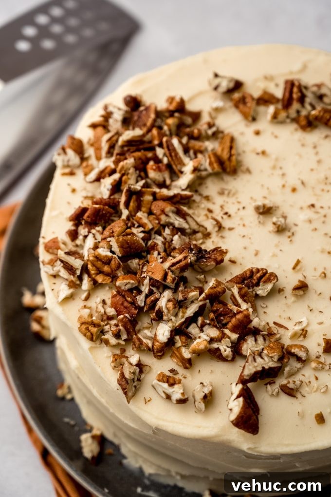 Decadent Butter Pecan Layer Cake Recipe 15 A butter pecan cake on a plate.