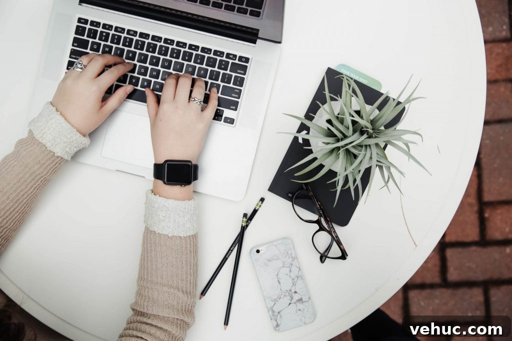 Boost Your Genealogy Research with Streamlined Workflow Tips 4 Hands on an open laptop with a plant next to it.