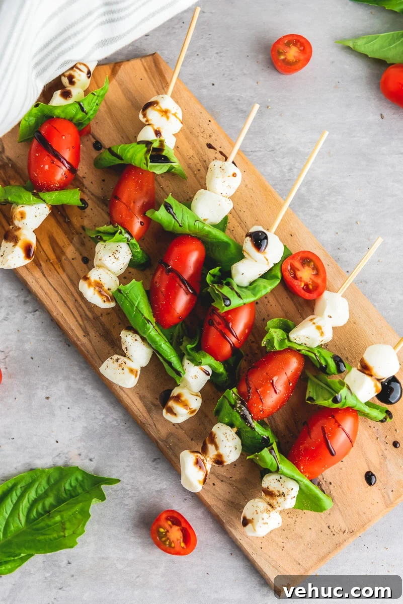 Christmas Brunch Finger Foods to Impress Guests 12 Caprese skewers overhead view on wooden board.