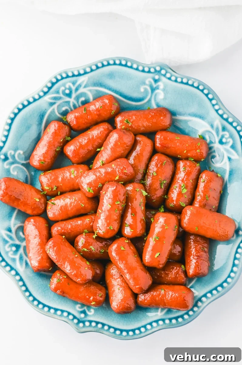 Christmas Brunch Finger Foods to Impress Guests 8 Crockpot little smokies served on a blue plate.
