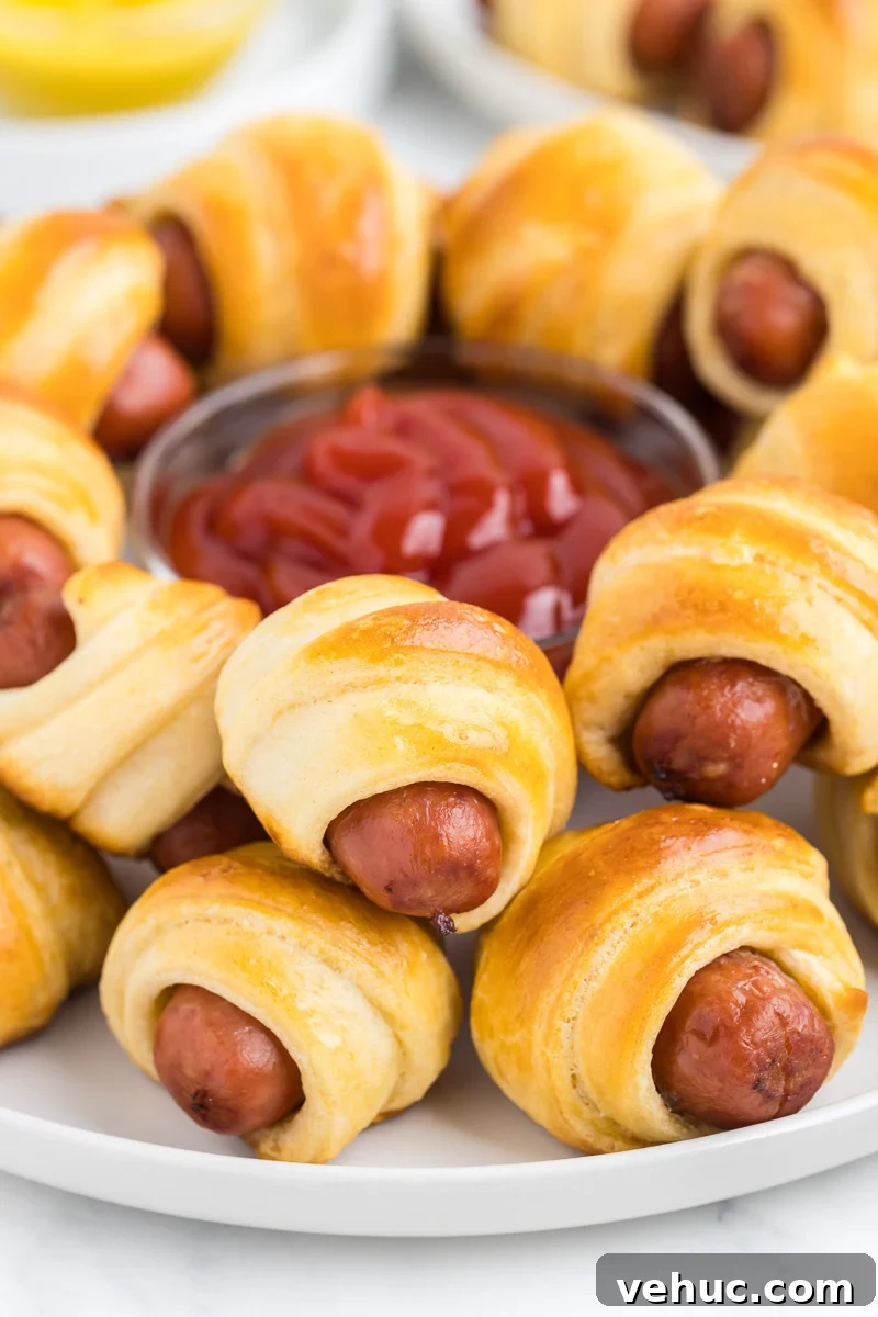 Christmas Brunch Finger Foods to Impress Guests 9 Pigs in a blanket on a plate prepared for snacks for movie night.