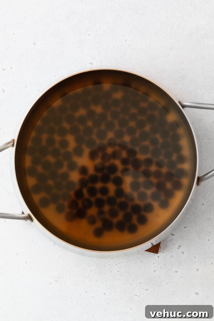 Mango Bubble Tea: Refreshing Homemade Boba Recipe 5 Cooking boba pearls in a large pot.