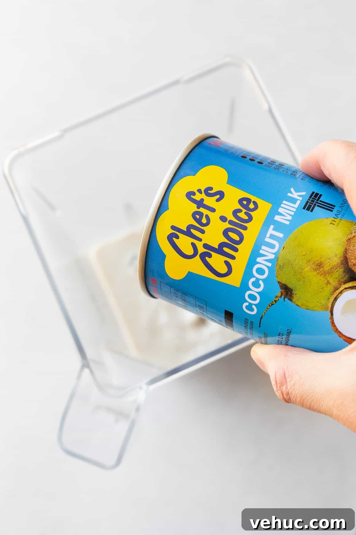 Mango Bubble Tea: Refreshing Homemade Boba Recipe 8 Adding Chef's choice coconut milk to a blender.