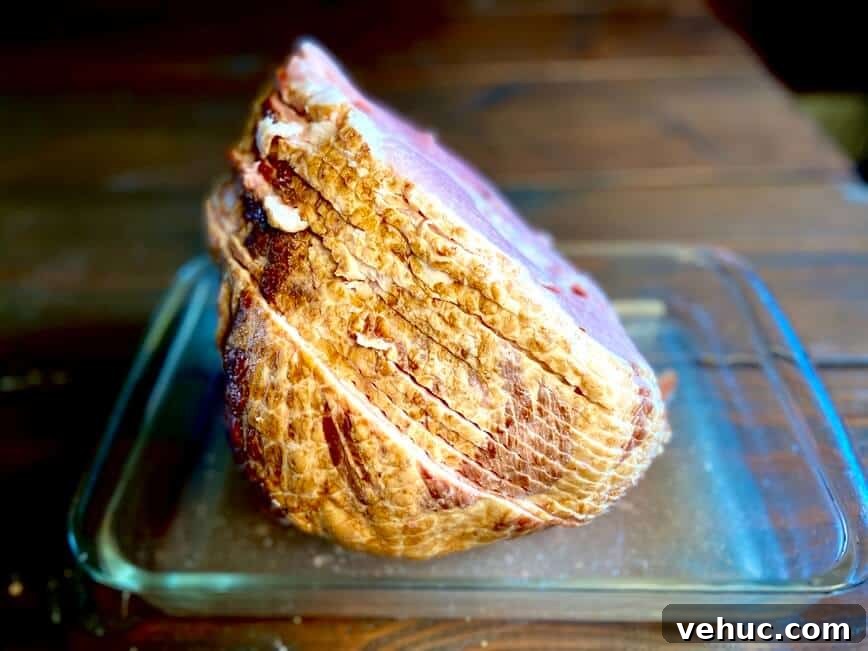 Sweet Brown Sugar Glaze for Ham: Simple Recipe for Holidays 4 Uncooked ham in baking dish.