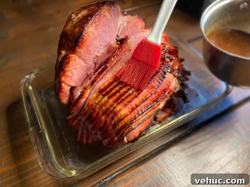 Sweet Brown Sugar Glaze for Ham: Simple Recipe for Holidays 6 Brushing glaze onto ham.