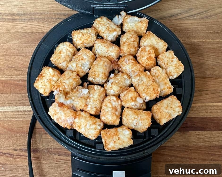 Crispy Tater Tots Made in a Waffle Iron: Quick Stove-Free Recipe 5 frozen tater tots in a waffle iron.