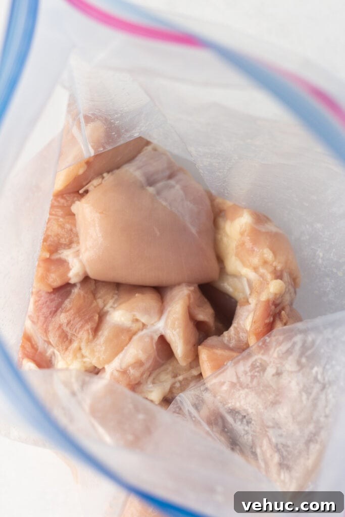 raw boneless skinless chicken thighs in a plastic ziploc bag.
