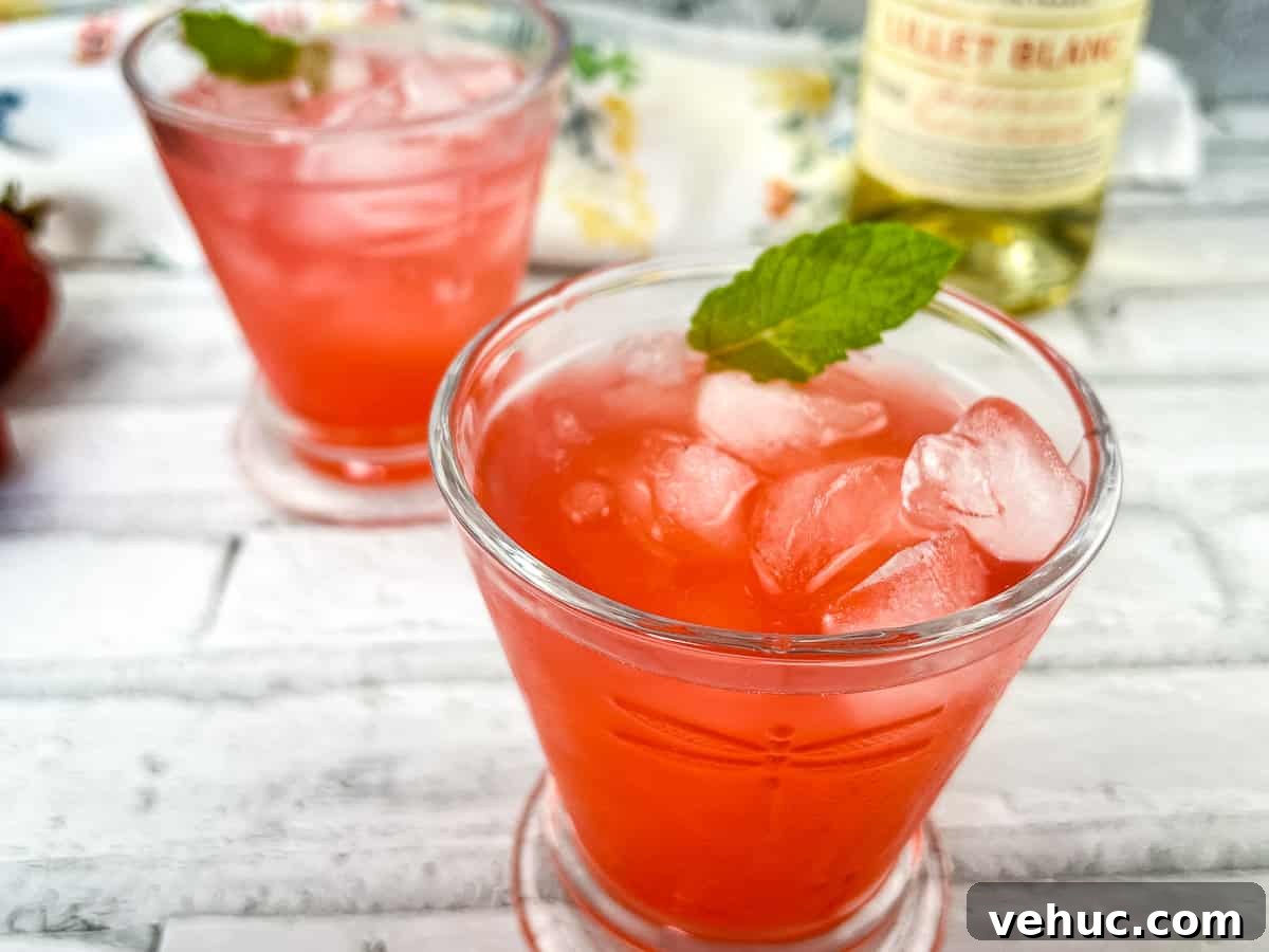 11 Strawberry Recipes That Highlight Their Sweet-Tart Flavor 13 Two glasses of strawberry lillet crush with mint leaves.
