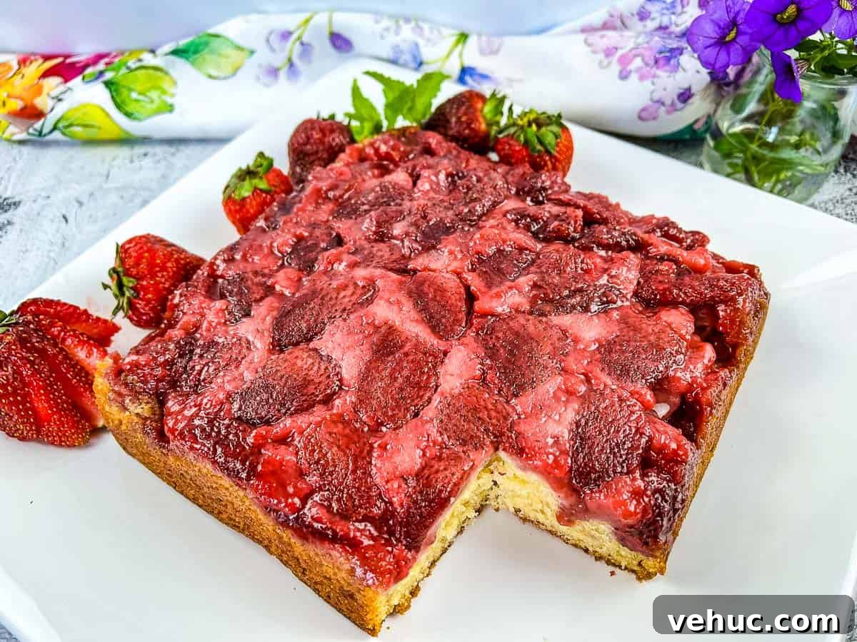 11 Strawberry Recipes That Highlight Their Sweet-Tart Flavor 4 Strawberry Upside Down Cake with a slice missing.