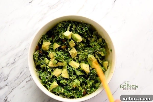 Creamy Avocado Massaged Kale Salad with Lemon Vinaigrette 6 Stirring the salad