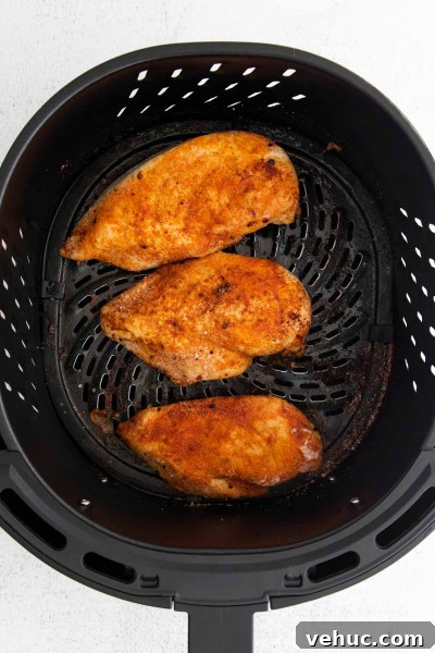 Crispy Air Fryer BBQ Chicken Recipe for Tender, Smoky Flavor 5 cooked chicken breast in air fryer basket