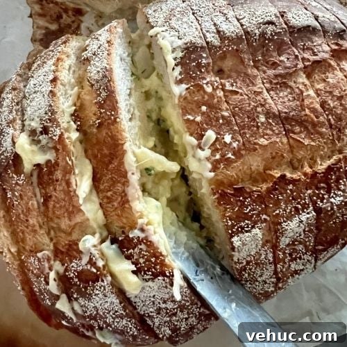 Using a butter knife, spread the garlic butter onto the sourdough slices, being generous with the butter.