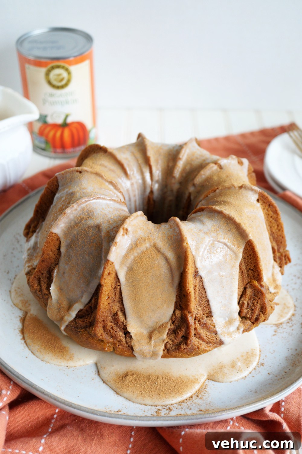 Vegan Pumpkin Spice Bundt Cake Recipe for Fall Gatherings 4 angled shot of pumpkin spice bundt cake on plate