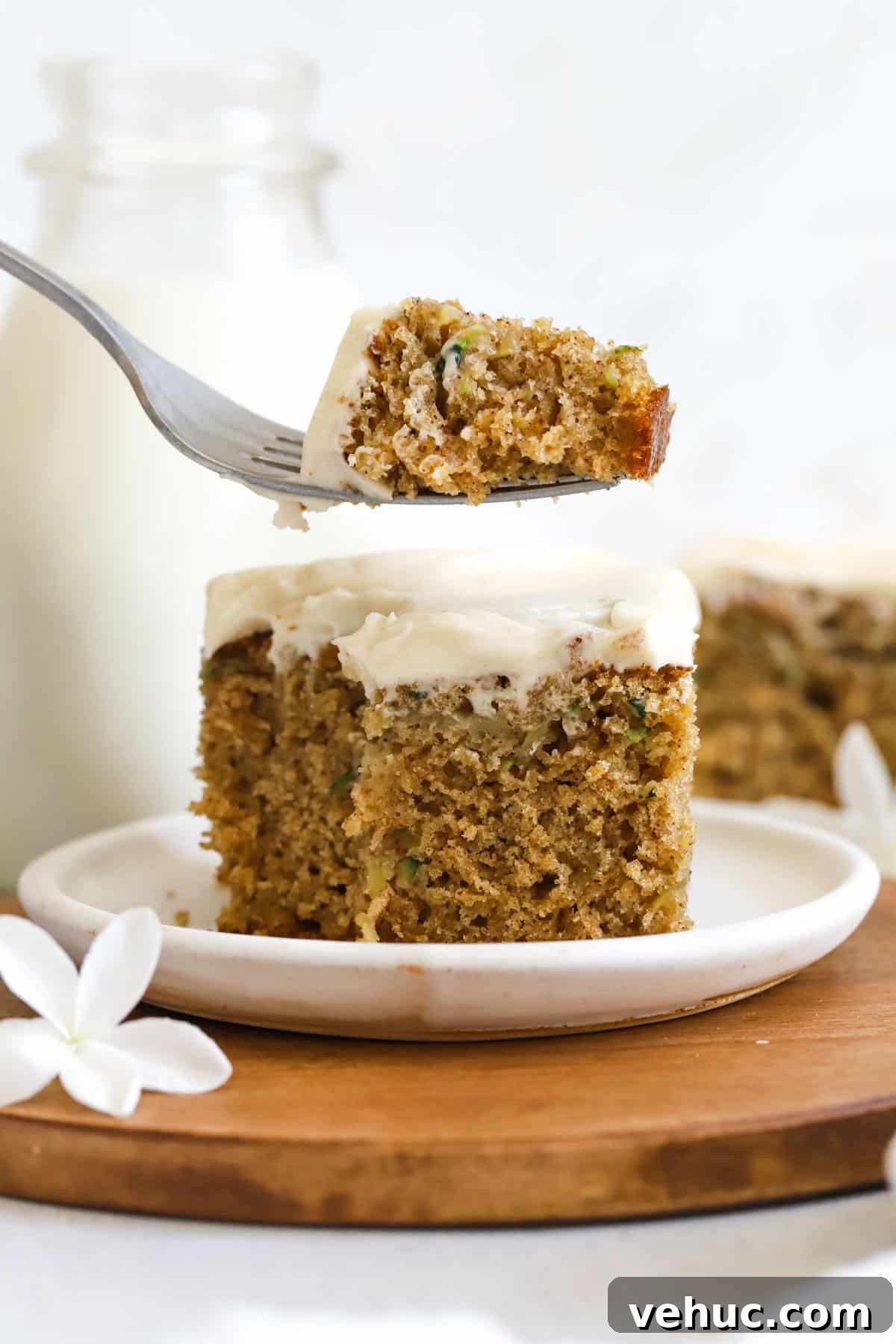 Gluten-Free Zucchini Cake with Brown Butter Cream Cheese Frosting 9 a fork taking a bite out of a slice of gluten-free zucchini cake with brown butter cream cheese frosting