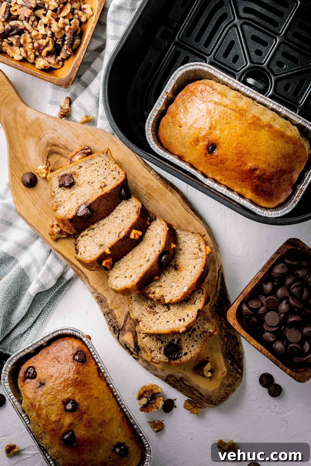 Overhead photo of banana bread made in the air fryer, one loaf in the pan and one loaf sliced