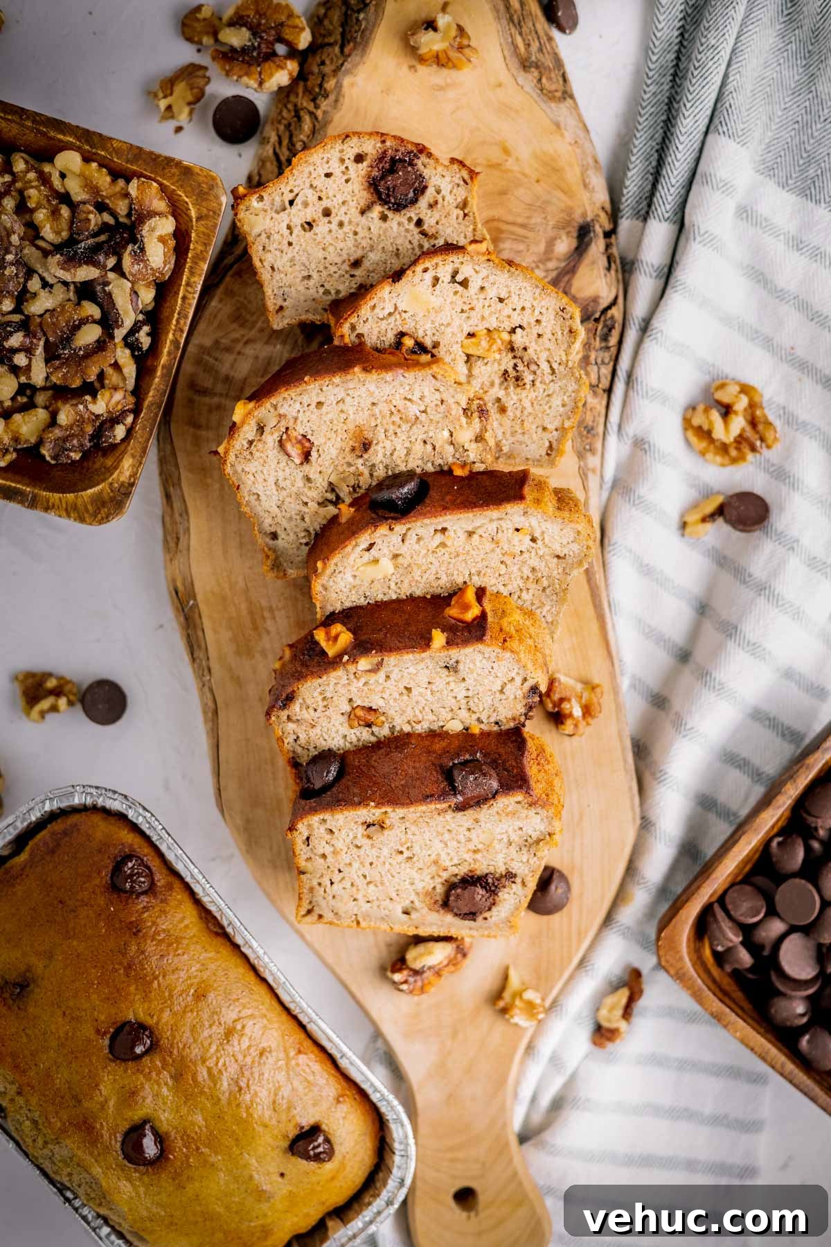 Overhead photo of sliced air fryer banana bread on a wood board