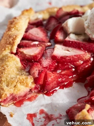 A side view of a slice of the Sourdough Discard Strawberry Galette.