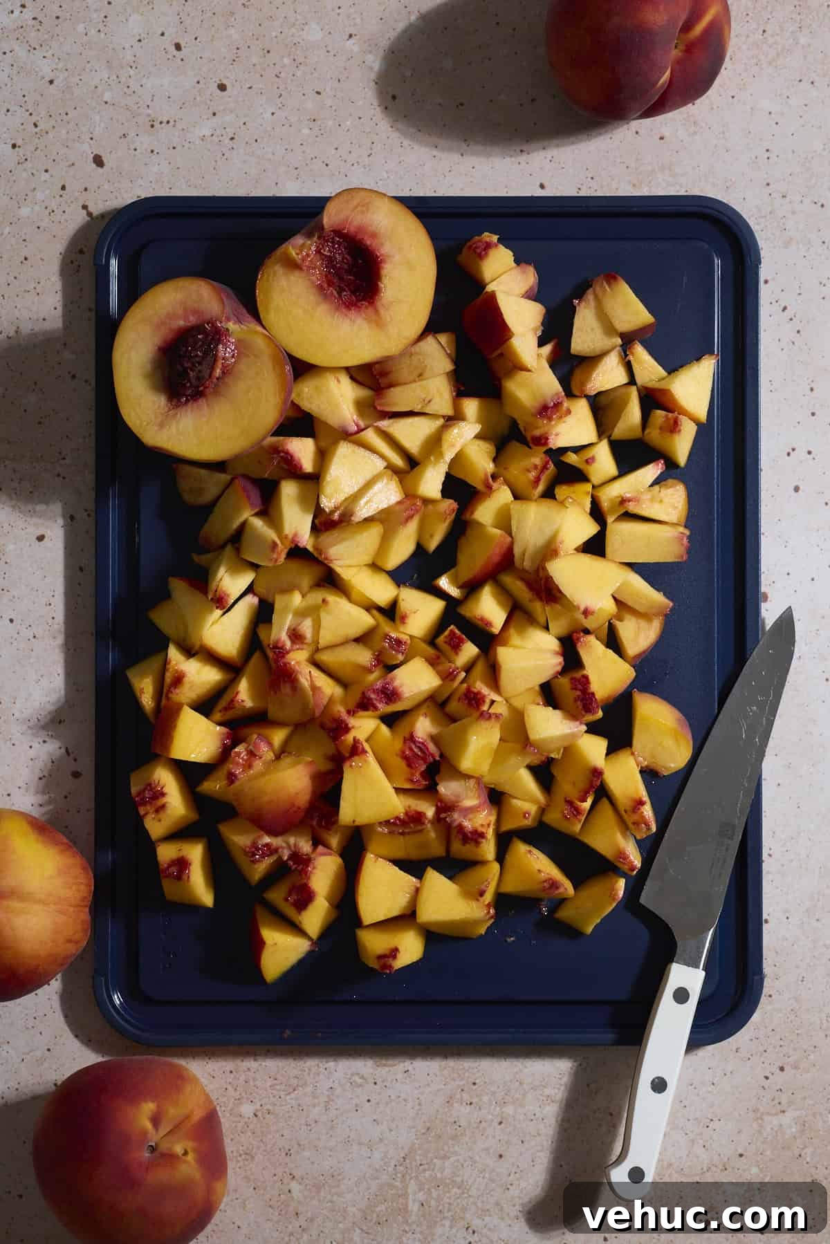 Sourdough Peach Cobbler Recipe: Rustic Peach Cobbler with Tangy Crust 4 Chopped peaches on a cutting board.