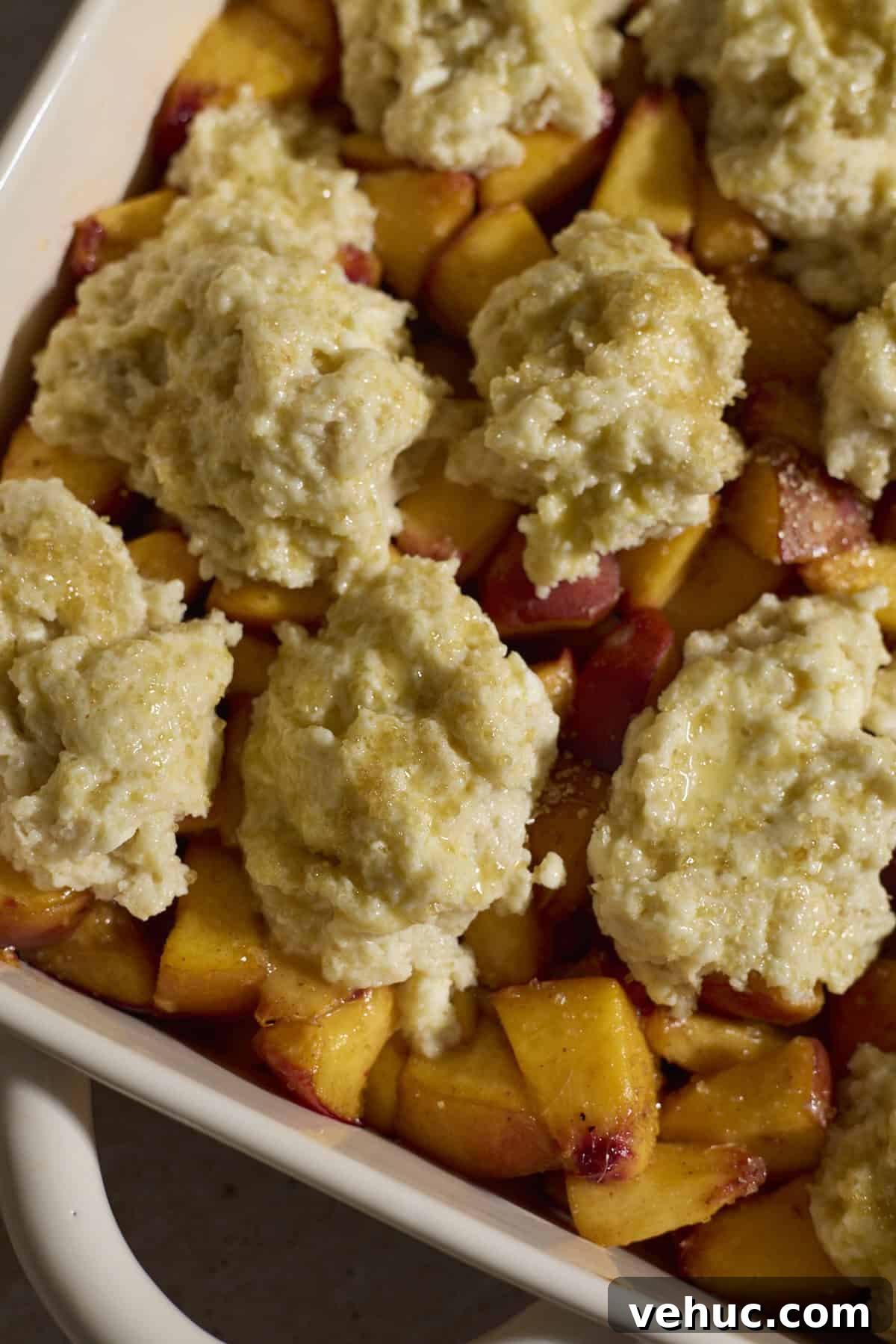 Sourdough Peach Cobbler Recipe: Rustic Peach Cobbler with Tangy Crust 9 Topping on top of the chopped peaches.