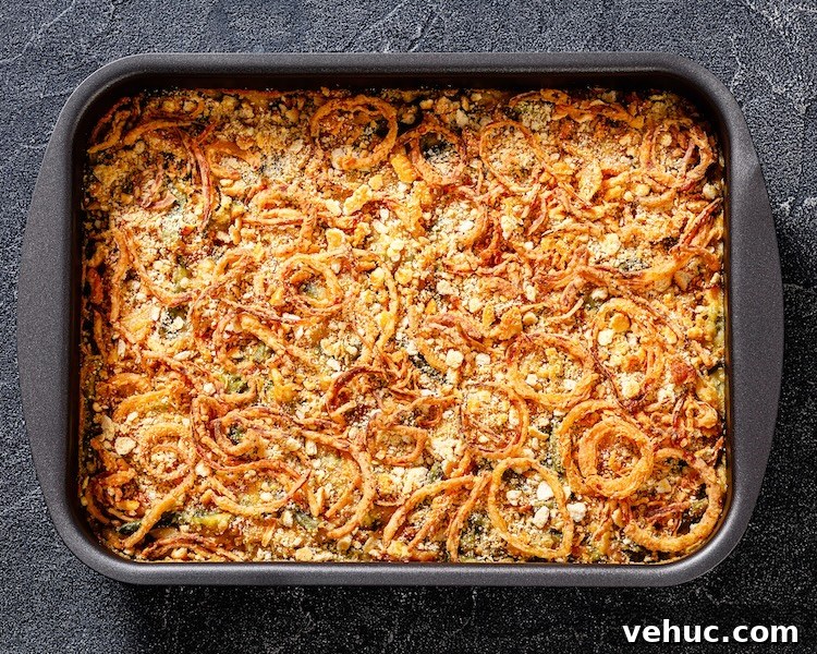 Creamy Green Bean Alfredo Casserole Recipe 3 Green bean casserole in a large dish topped with crispy French fried onions and Parmesan cheese.