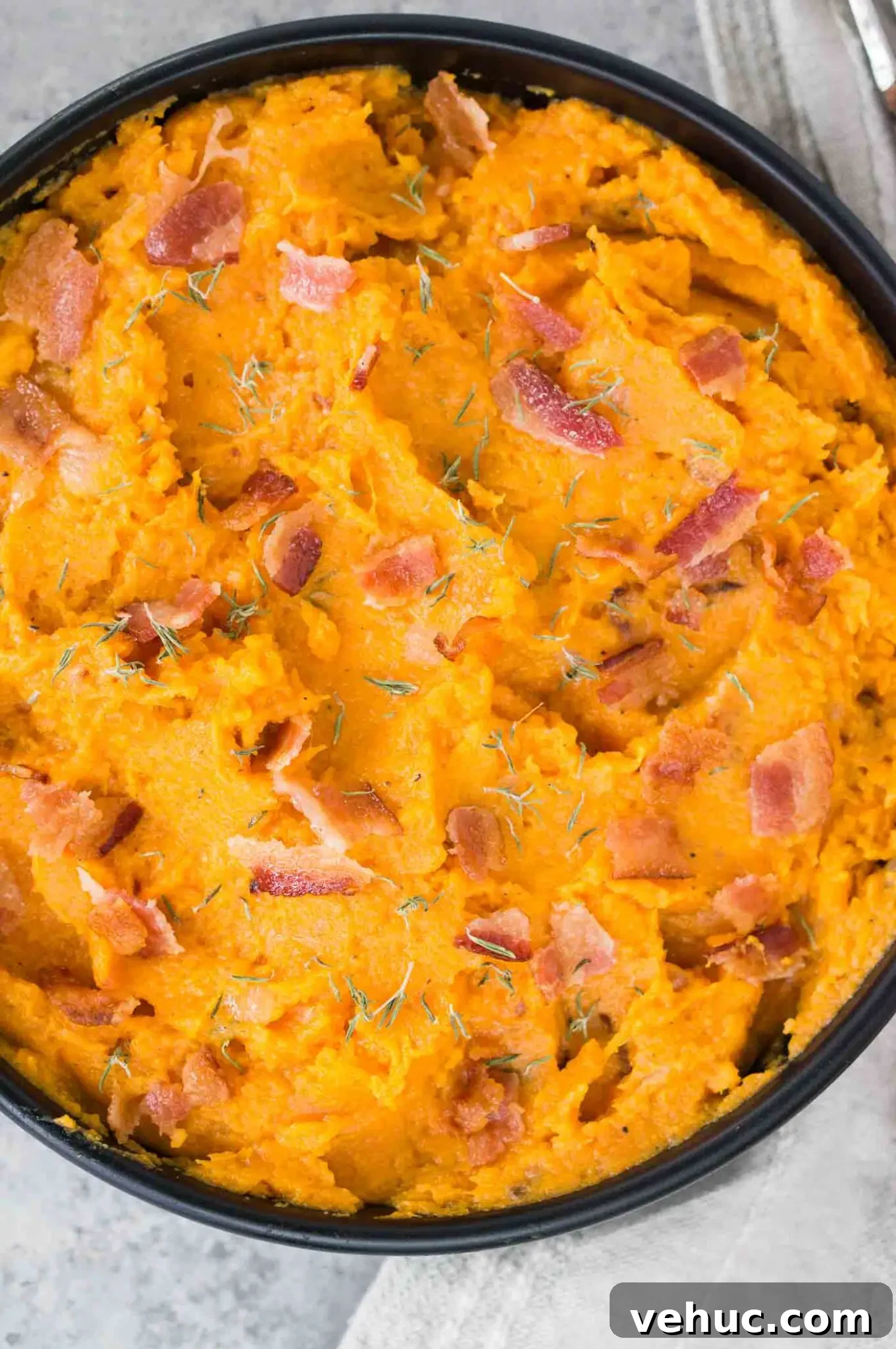Creamy Mashed Sweet Potatoes with Crispy Bacon 8 close up image of mashed sweet potatoes in a black bowl