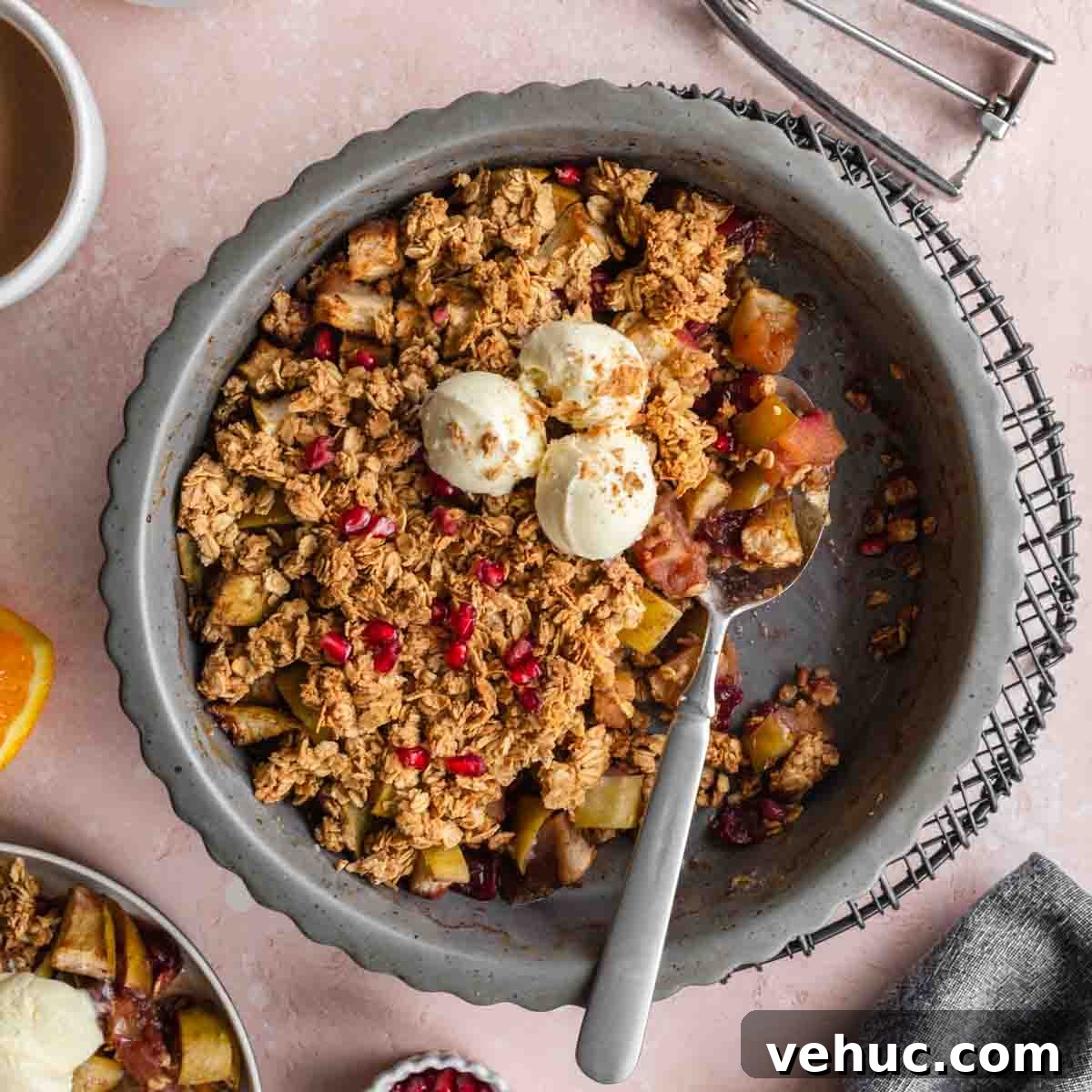 Apple Cranberry Crisp: Gluten-Free Vegan Recipe for Fall Dessert 8 Overhead of cranberry apple crisp in a pie dish with some removed and ice cream on top.